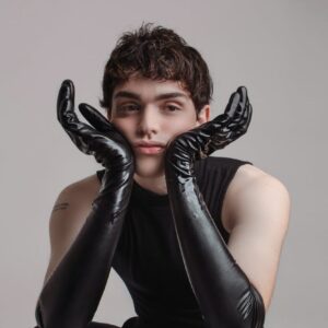 androgynous man in black cloths and gloves