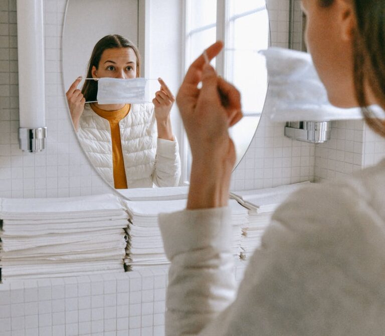 woman putting on a face mask